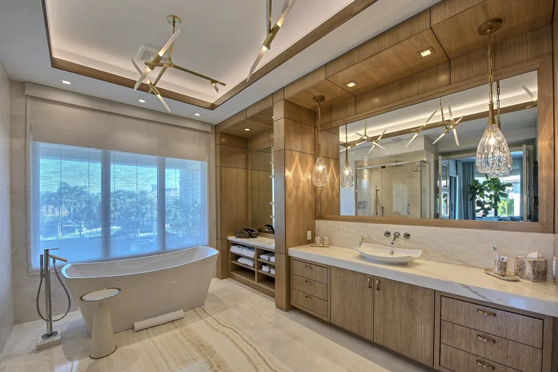 Primary bathroom with a freestanding soaking tub and crystal pendant lighting
