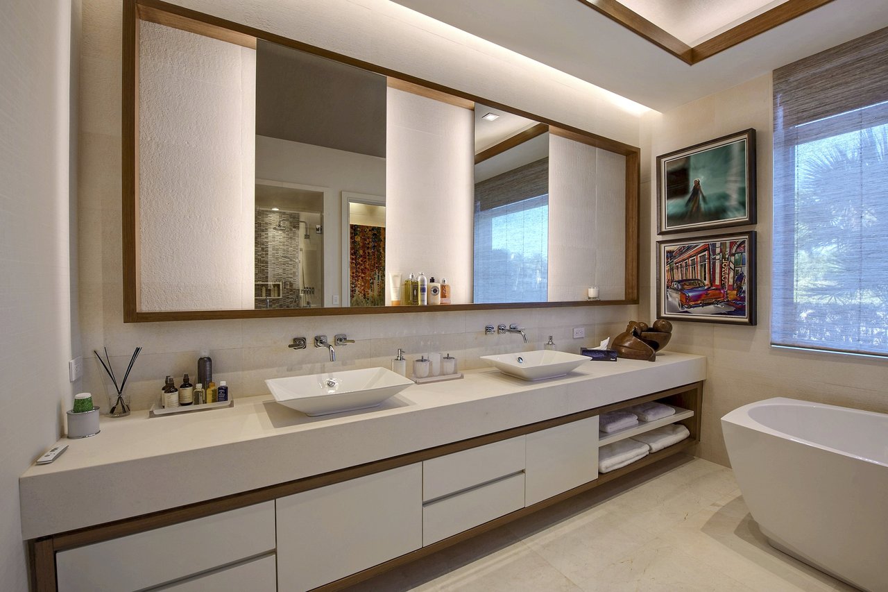 Modern bathroom with a floating double vanity, vessel sinks, and a freestanding soaking tub, built by Wolf in the Woods