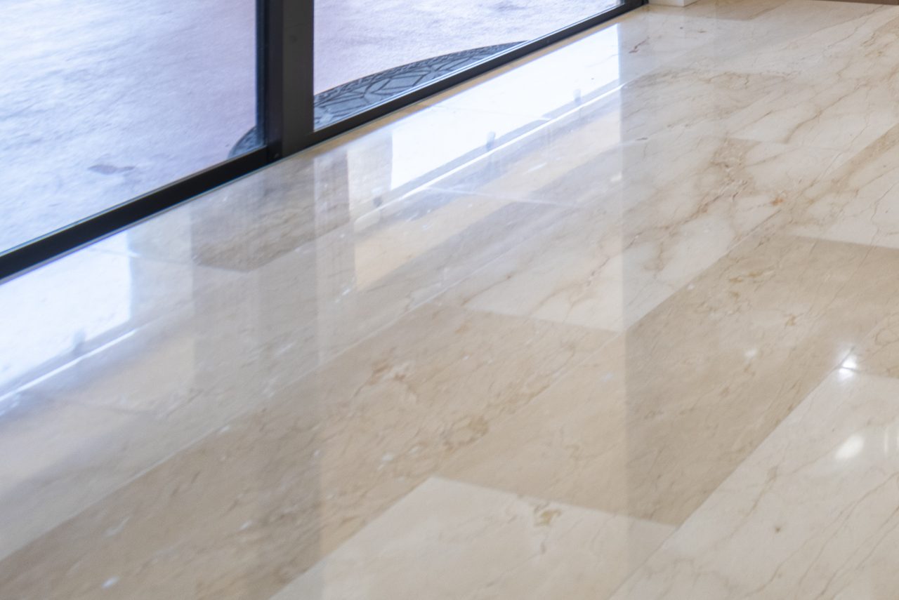 Close-up of polished marble tile flooring showing veining and joints
