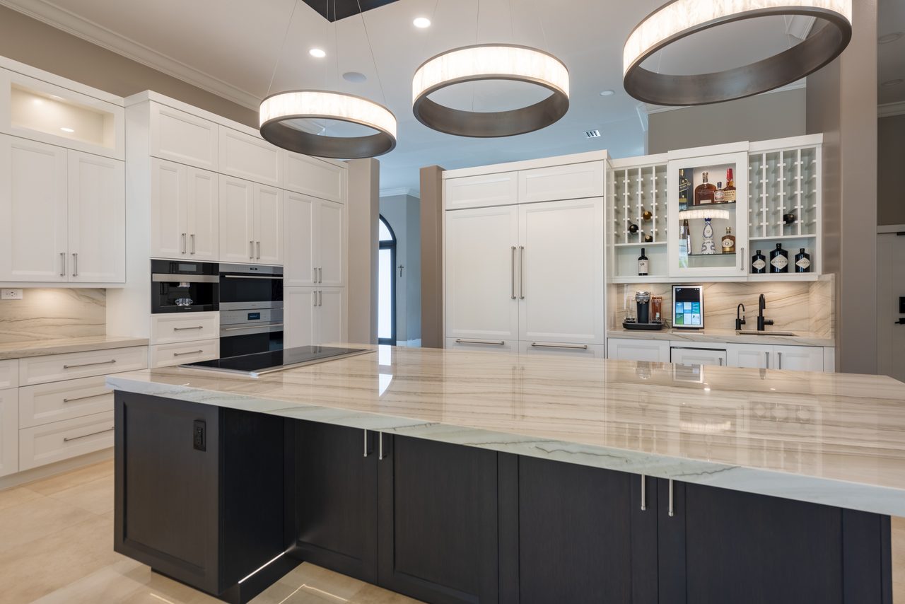Quartzite island with waterfall edge, integrated wine storage and bar seating