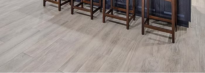 Luxury vinyl plank flooring in a light grey wood-look finish